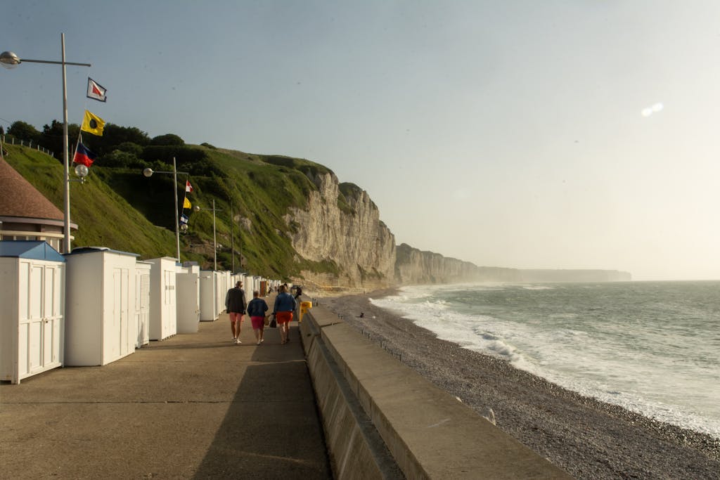 Explore the scenic beachfront of Fécamp, Normandy with iconic cliffs and promenade view.
