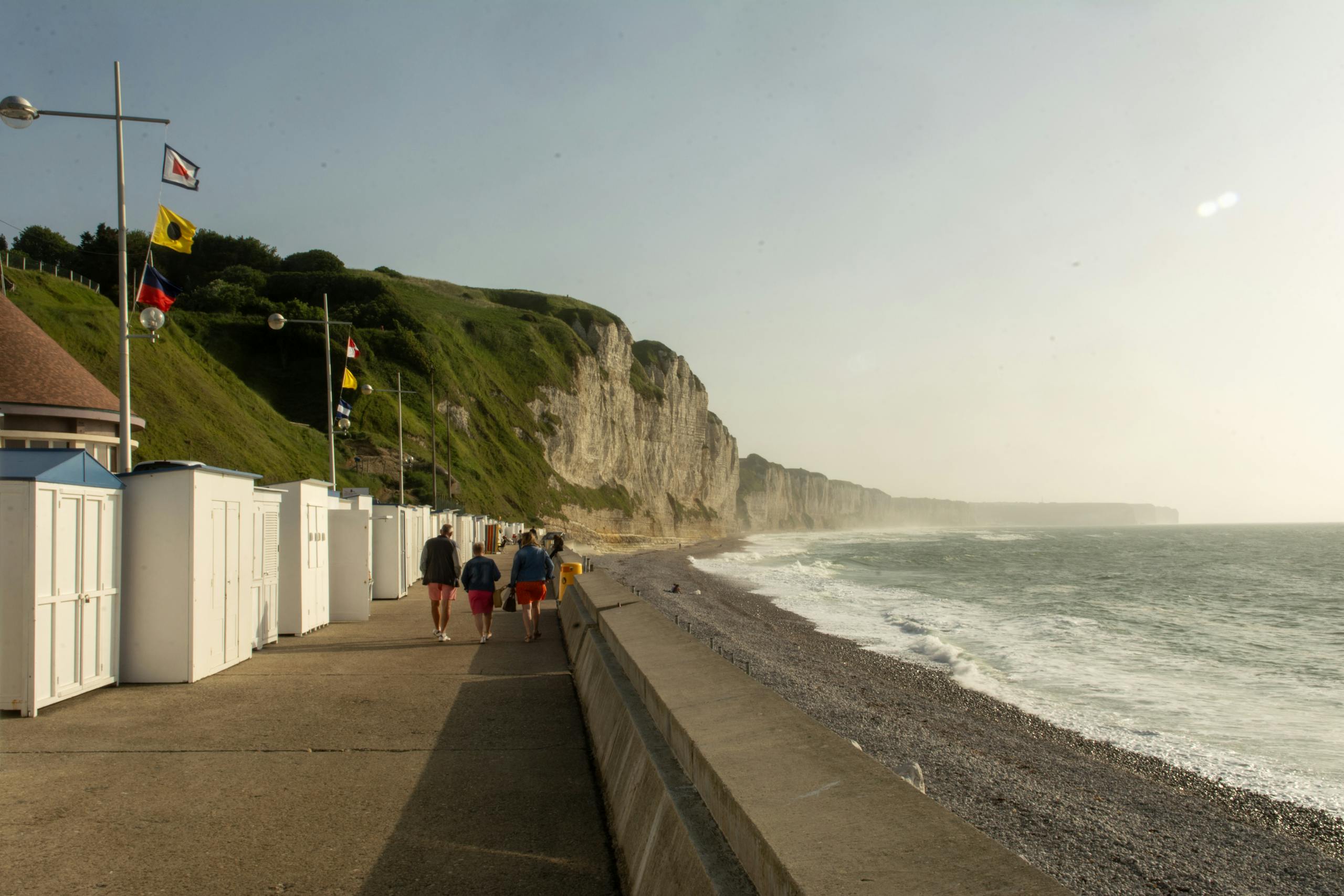Explore the scenic beachfront of Fécamp, Normandy with iconic cliffs and promenade view.