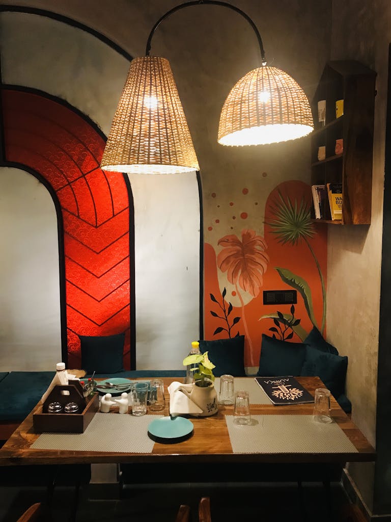 Warm and inviting restaurant setting with unique lighting and colorful mural.
