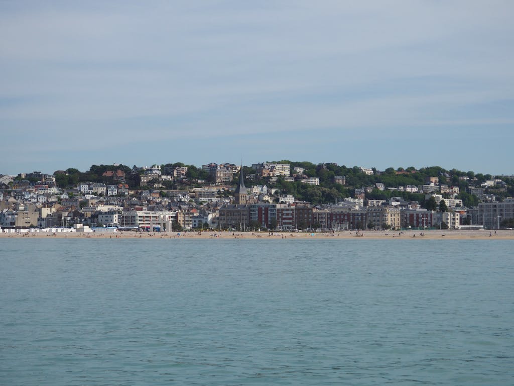 Explore the picturesque Le Havre beach cityscape with distant hills and buildings, Normandie, France.